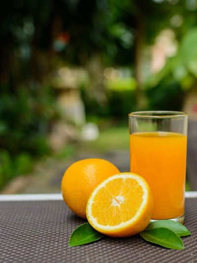 Oranges Next To Glass Of Juice