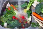 Washing Of Garden Vegetables In A Sink