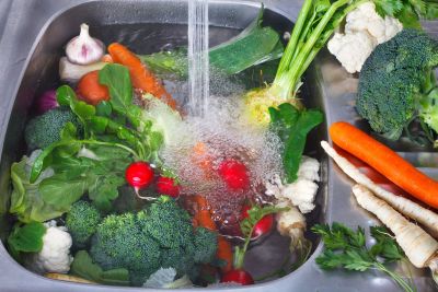 Washing Of Garden Vegetables In A Sink