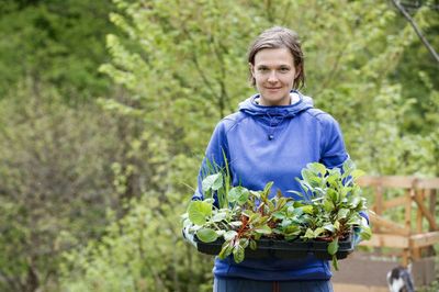 Person Holding A Tray Of Plants And Vegetables