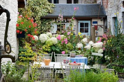 Pocket Garden Design With Outdoor Table And Colorful Flowers
