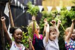 Kids Holding Vegetables in their Agrihood Community