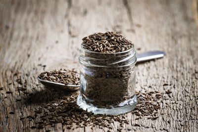 Glass Jar And Spoon Full Of Caraway Seeds