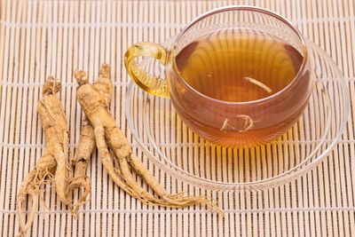 Ginseng Roots Next To A Cup Of Tea