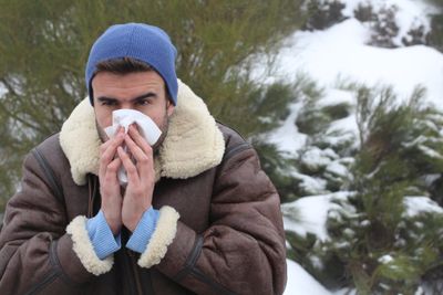 Person Outdoors In The Snow Sneezing