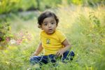 Baby Sitting In Grassy Garden