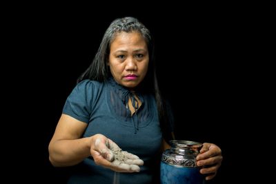 Lady Holding Urn And Cremated Ashes