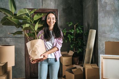 Lady Holding A Plant Wrapped In packaging
