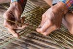 Hands Weaving A Basket