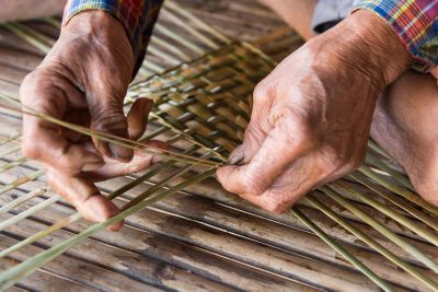 Hands Weaving A Basket