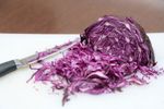 Omero Red Cabbage Sliced On Cutting Board