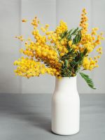 Bouquet Of Bright Yellow Flowers In White Glass Vase