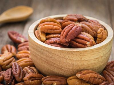 Wooden Bowl Full And Surrounded With Pecans
