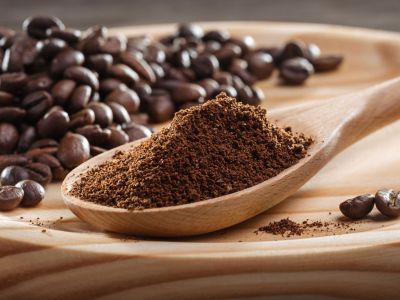Wooden Plate Of Coffee Beans And Coffee Grounds
