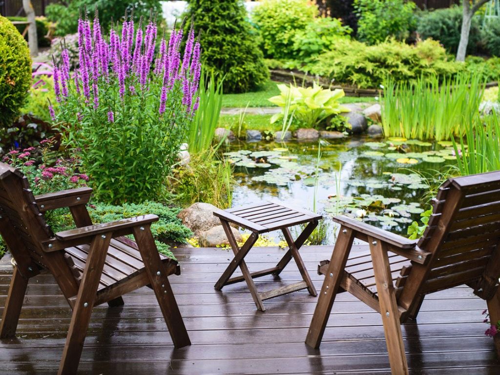 Outdoor seating by a small garden pond