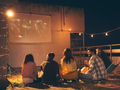 People On A Rooftop Watching A Movie