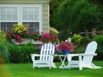 Front Yard With White Lawn Furniture And Flowers
