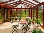 A Sunroom Filled With Potted Plants