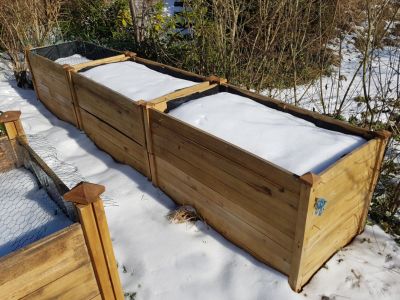 Vegetable Garden Beds In The Winter Covered In Snow