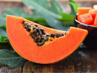 A Slice Of Papaya Fruit With Seeds