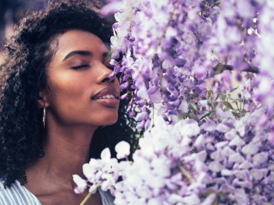 Woman Smelling A Fragrant Garden