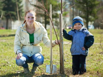 Woman And Child Planting A Tree
