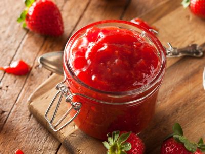 Strawberries Surrounding A Jar Of Red Jam
