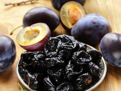 Plums Around A Bowl Of Prunes