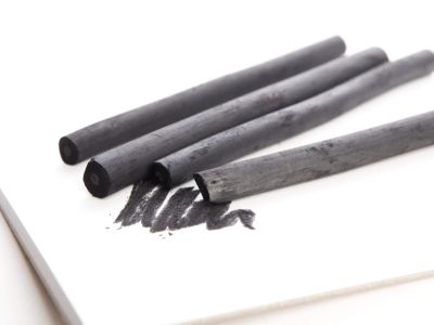 four sticks of charcoal on a piece of paper