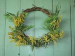 wreath with leaves and flowers hanging on door