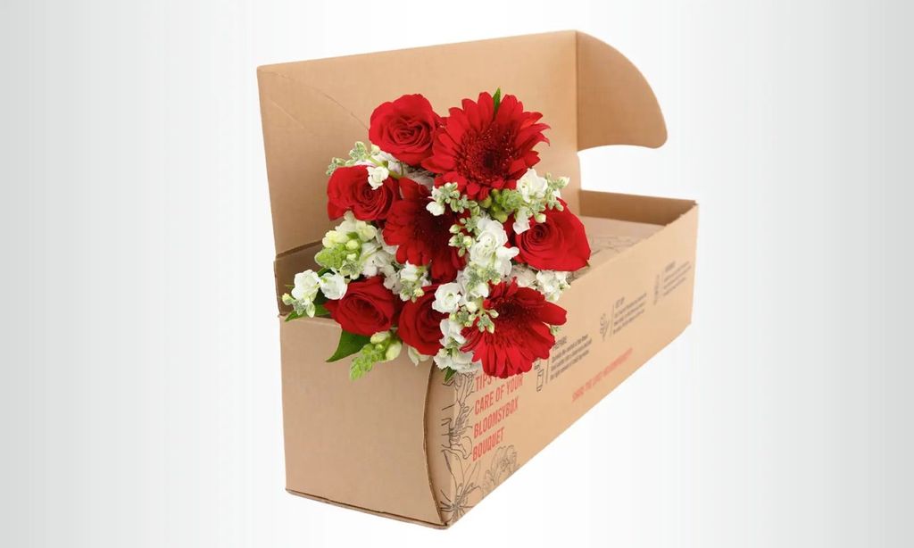 A shipping box with a red and white bouquet.