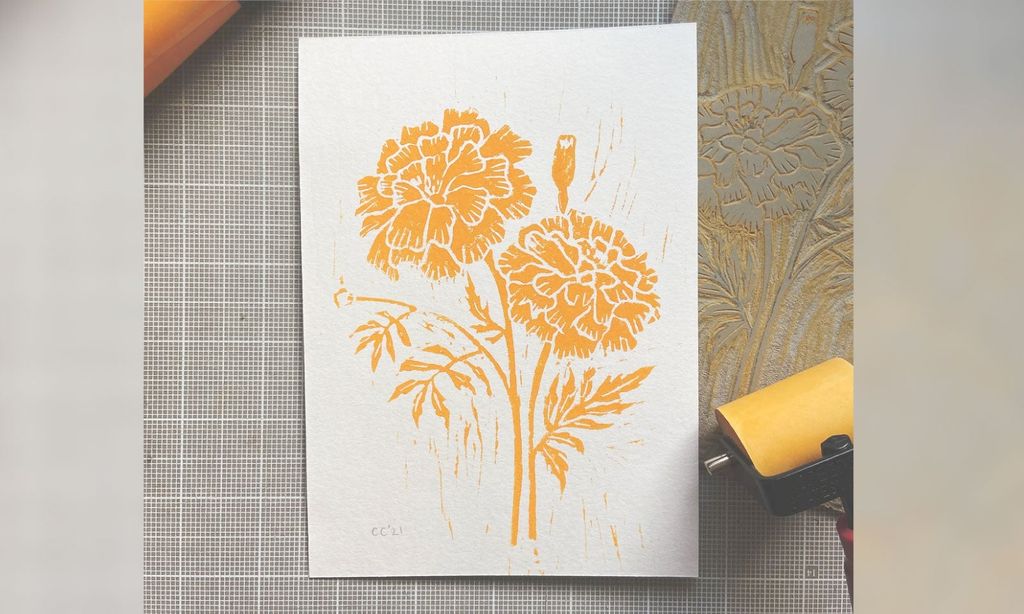 A gold colored marigold block print