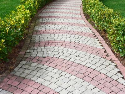 A beautiful permeable pathway of small interlocking red and white paving stones