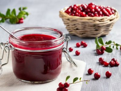 A basket of lingonberries and a jar of lingonberry jam