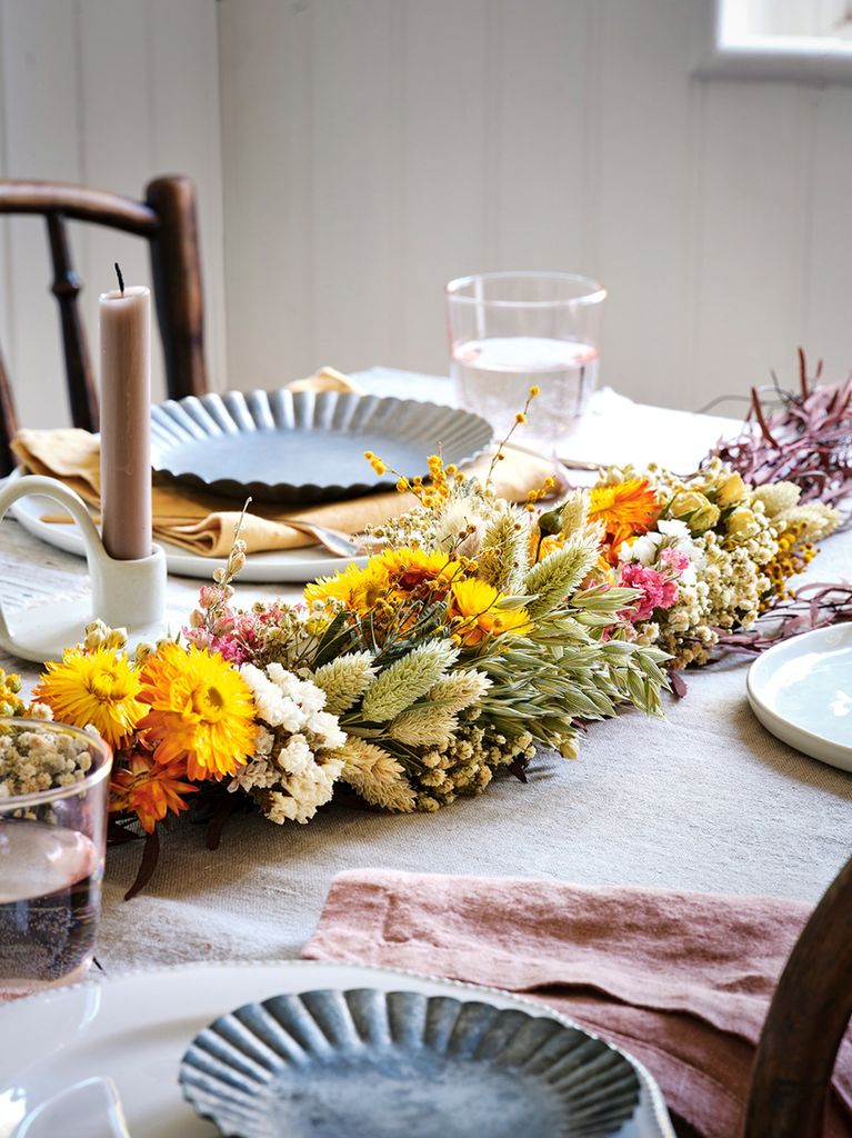 Rustic table setting with colorful dried flower garland